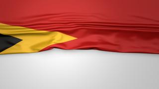 East-Timor National Flag, Flag folded in half and placed on white paper