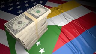 Comoros National Flag, American dollars and flag placed on top of the American flag