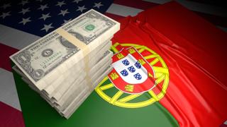 Portugal National Flag, American dollars and flag placed on top of the American flag