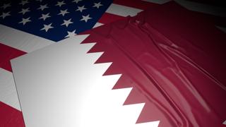 Qatar National Flag, A flag placed on top of an American flag on a desk in a dark space