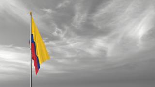 Colombia National Flag, The national flag and flagpole visible from afar against a black and white sky background